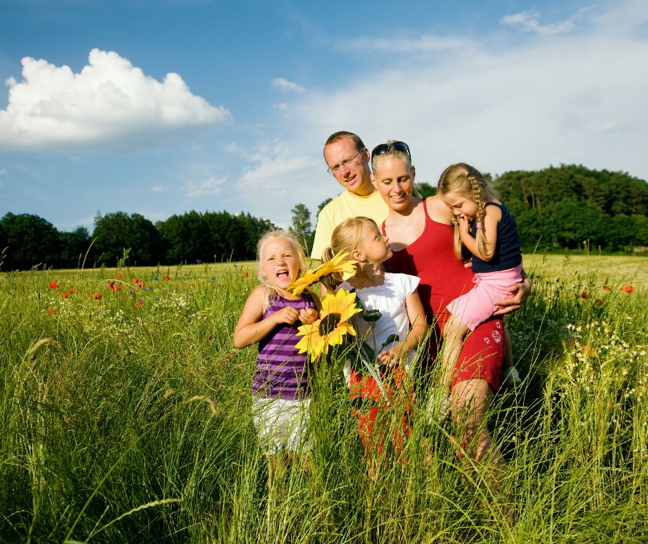 Summer Pest Control with a family enjoying a field and a big sunflower.